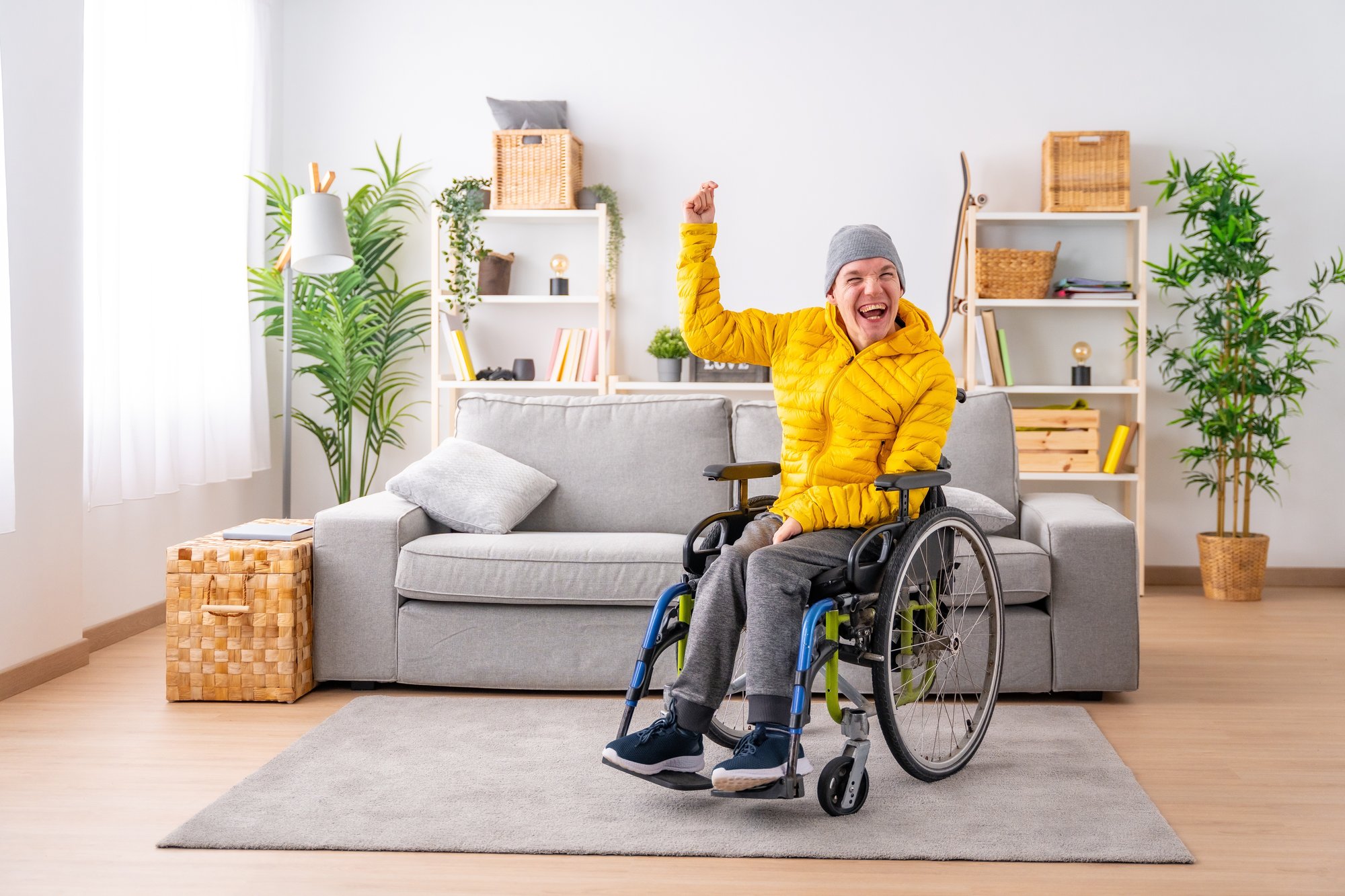 Happy man wheelchair indoors_shutterstock_2416274055